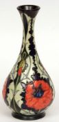 A Moorcroft Large Spill Vase, decorated with a Poppy design on a dark blue ground, circa late 20th