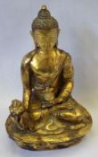 An Oriental gilded Bronze Figure of a seated Deity clutching a Sensor in his left hand and wearing