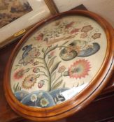 A 19th Century Oval Framed Needlework Panel, depicting exotic bird amongst foliage, 18 ½” wide