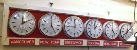 A mid-late 20th Century large rectangular framed set of six Metamec Electric Wall Timepieces,
