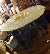 An early 20th Century Brass Tray Top Benares Table, the round top to a six-legged hardwood base with
