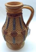 A Doulton Lambeth Stoneware Vase, decorated with raised geometric design and floral rosettes on a