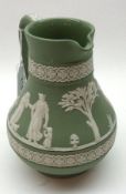 A Wedgwood Green Jasperware Jug, typically decorated with classical scenes, 6” high