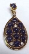 A hallmarked 9ct Gold Teardrop Design Pendant, set with Cabochon Sapphires and small brilliant cut