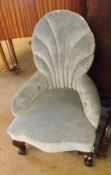 A small Victorian Blue Upholstered Nursing Chair, with serpentined front, raised on short cabriole