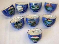 A set of eight Oriental Tea Bowls, all painted in colours with panels of scenes depicting Mount