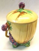 A Clarice Cliff “My Garden” Circular Covered Biscuit Barrel with a wicker looped handle, the lid,