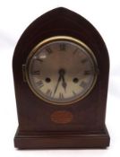 An Edwardian Mahogany Mantel Clock with arched top, circular face with silvered dial and black Roman
