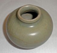 A Song Dynasty Celadon Jarlet of circular baluster form, 2 ¼” high