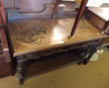 A late Victorian Oak Two Drawer Side table, with galleried back, carved detail, raised on ring