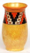 A Charlotte Rhead Tapering Vase, decorated with a geometric frieze on an orange and ochre