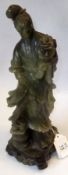 A large Oriental Jade or Jadeite Figure of a Young Girl clutching a sprig of Foliage, 20th Century,