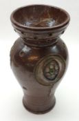 An unusual Royal Doulton Stoneware Vase, decorated with abstract floral panels on a brown