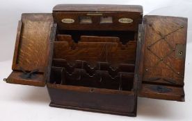 A late 19th Century Oak Two Door Sloped Front Stationery Box, with fitted interior and single drawer