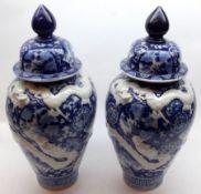 A pair of Blue Imari Covered Vases of baluster form, the bodies relief moulded with dragons and also