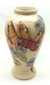 A Moorcroft Baluster Vase, decorated with a Butterfly and Scattered Floral Sprig design on a white