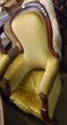 A Large Victorian Mahogany Framed Armchair, upholstered in golden fabric, raised on front turned