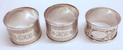 A pair of Edwardian foliate engraved Napkin Rings, Chester 1907 and a similar single example,