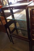 A small late 19th/early 20th Century Glazed Shop Display Cabinet with two glass shelves, raised on a