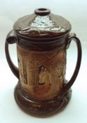 A Large Bretby Double-Handled Covered Jar, decorated with a continuous scene of rural Oriental