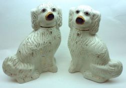 A pair of large 19th Century Staffordshire Models of spaniels, typically formed and decorated with