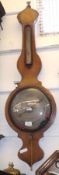 A 19th Century faded Mahogany or Rosewood Cased Wheel Barometer, with onion top over single scale