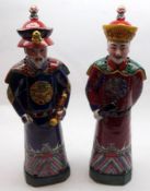 A pair of 20th Century Oriental Figures, modelled as an old man and his apprentice, decorated