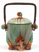 A Clarice Cliff “My Garden” Covered Circular Biscuit Barrel of tapering form with wicker handle, the