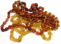 A Mixed Lot: two Cornelian Bead Necklaces; together with two Amber type Necklaces (4)
