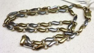 A hallmarked 9ct Yellow and White Gold wave link design Necklet, 41cm long and weighing approx