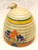 A Clarice Cliff Crocus pattern Honeypot, the lid with bee finial, Newport Pottery printed Bizarre