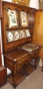 A 20th Century Reproduction Small Oak Dresser, the top with two shelves to the base which has five