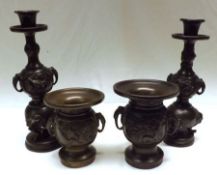 Two Chinese Bronze Candlesticks, the stems relief moulded with panels of birds and also with