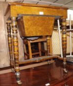 A Victorian Burr Walnut and Ebonised Sewing Table, the top opening to reveal a fitted interior and