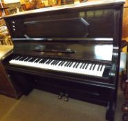 A late 19th/early 20th Century Upright Ebonised Cased Overstrung Piano, F Adam of Krefeld, 55” wide