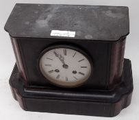 A Black Marble Mantel Clock with red veined pilasters, circular face with black Roman chapter