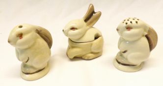 A Clarice Cliff Small Cruet, each modelled as rabbits and comprises a Lidded Mustard Pot, Salt and