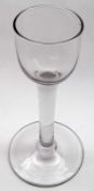 An 18th Century Wine Glass with plain bucket bowl, plain stem and spreading circular foot, 6” high