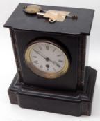 A Victorian Black Marble Mantel Timepiece with veined pilasters, circular white enamelled dial