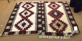 A pair of Turkish Kilim Rugs, decorated with central triple lozenges on a mainly cream, black and