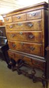 An 18th Century and later Walnut veneered Chest on Stand, the Chest with three short drawers and