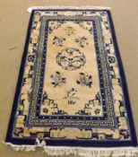 A Chinese Wool Superwash Carpet, central panel of floral sprigs and sprays, beige and blue field,