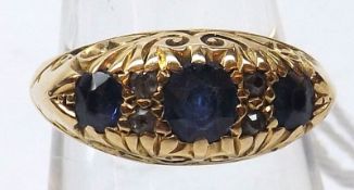 An Edwardian hallmarked 19ct Gold three mid-blue Sapphire and four small Diamond Ring, engraved