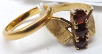 A yellow metal three stone Garnet Ring, engraved concave shoulders; together with a hallmarked