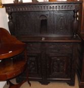 A heavily carved Oak Court Cupboard constructed from period timbers, the base with two doors and two