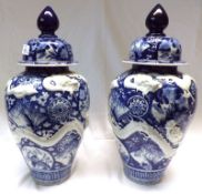 A pair of blue Imari Covered Vases of baluster form, the bodies relief moulded with dragons and also