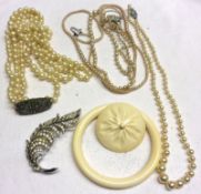 A Mixed Lot of Jewellery: an early 20th Century Ivory Bangle and Brooch; Pearl type Necklaces; Paste