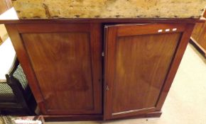 A Victorian Mahogany Two Door Cupboard, the two large panelled doors opening to a shelved