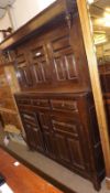 A large Oak Court Cupboard constructed of period timbers, the top with three panelled doors, the