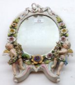 A late 19th/early 20th Century oval Dressing Table Mirror with floral encrusted china frame with